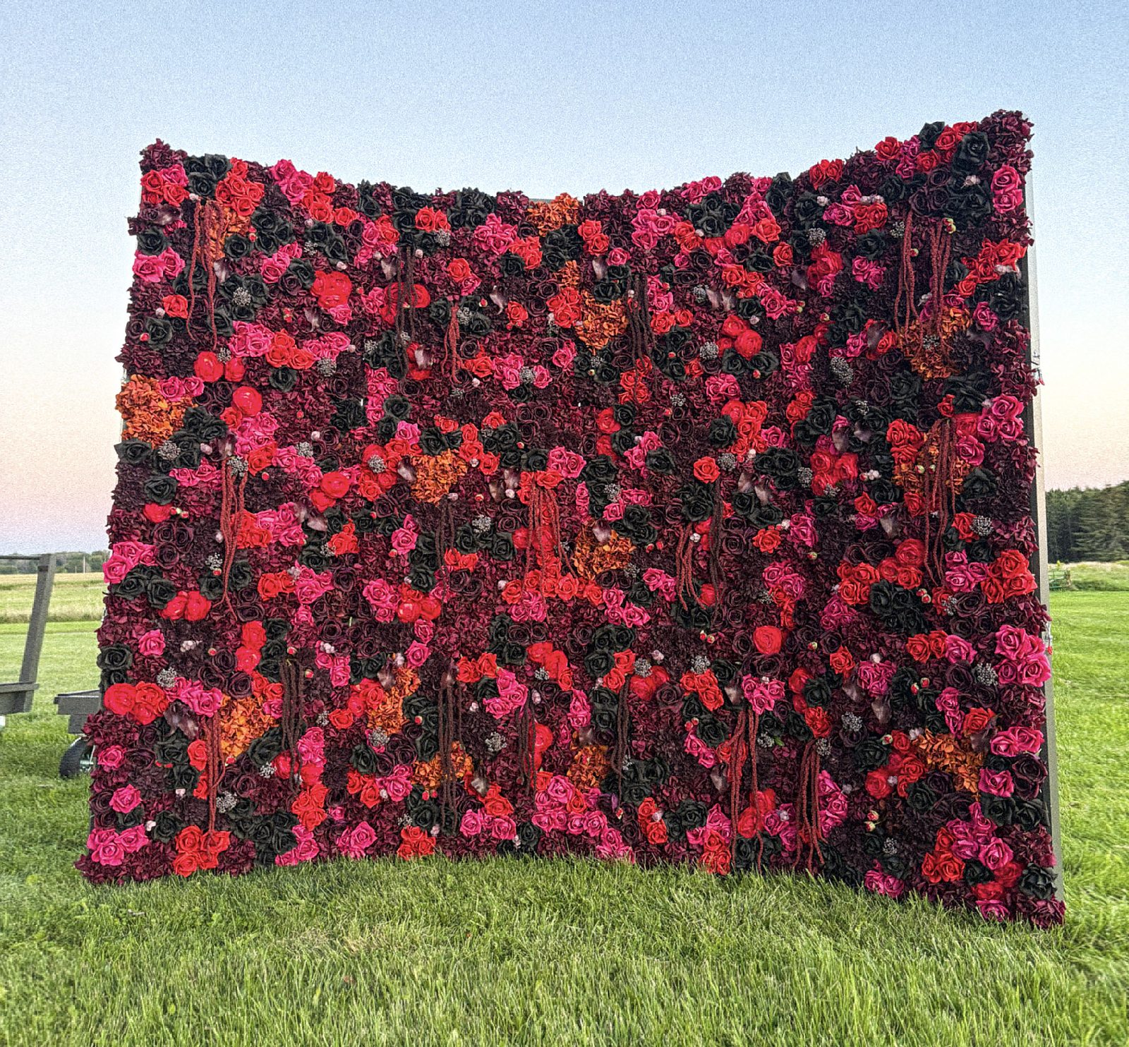 Dark moody burgundy and black Real Touch flower wall on a garden lawn — FLORINSKY backdrop for weddings in Toronto & the GTA