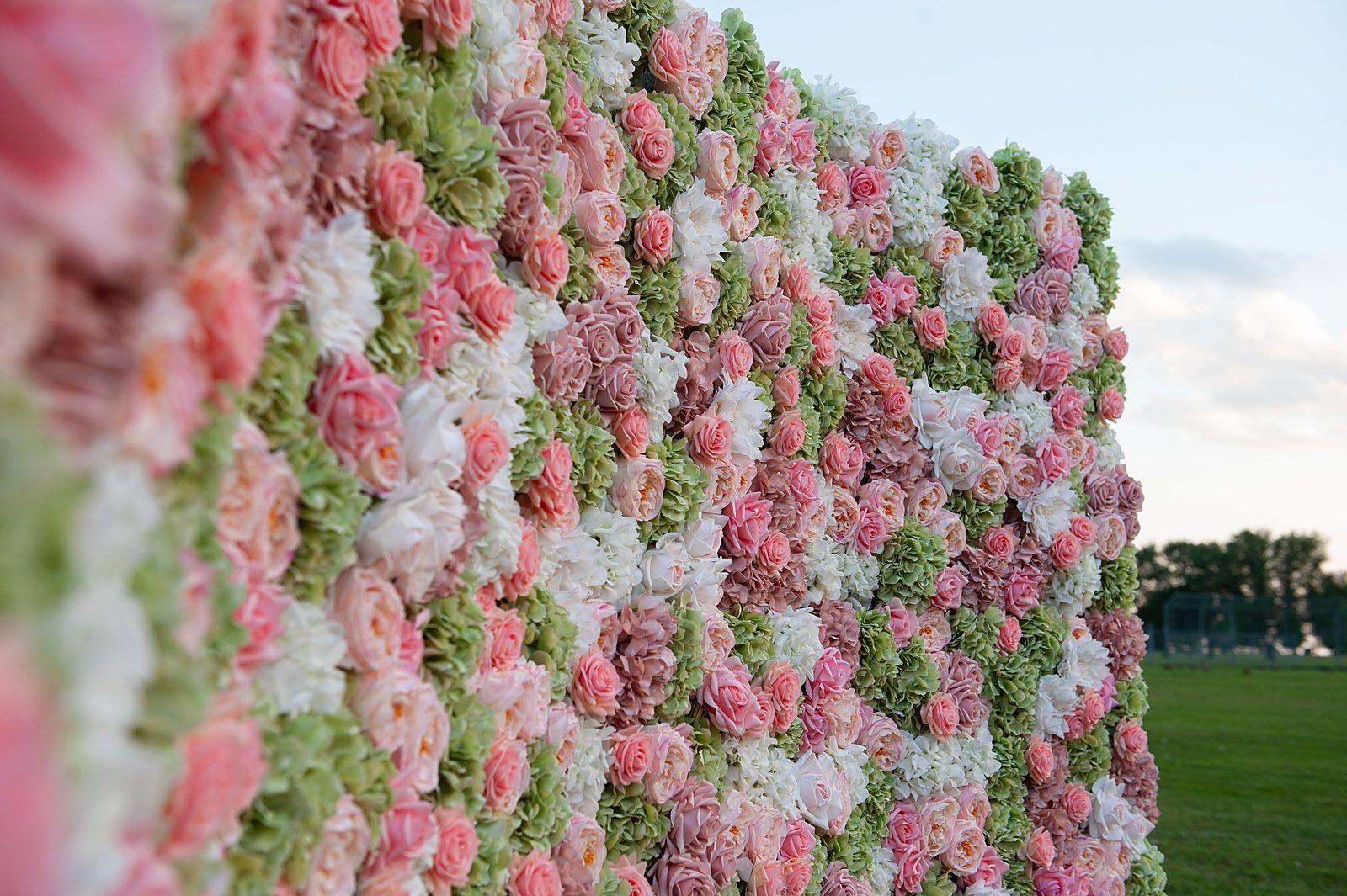 Close-up of the English Garden flower wall showing sage hydrangea and blush rose texture