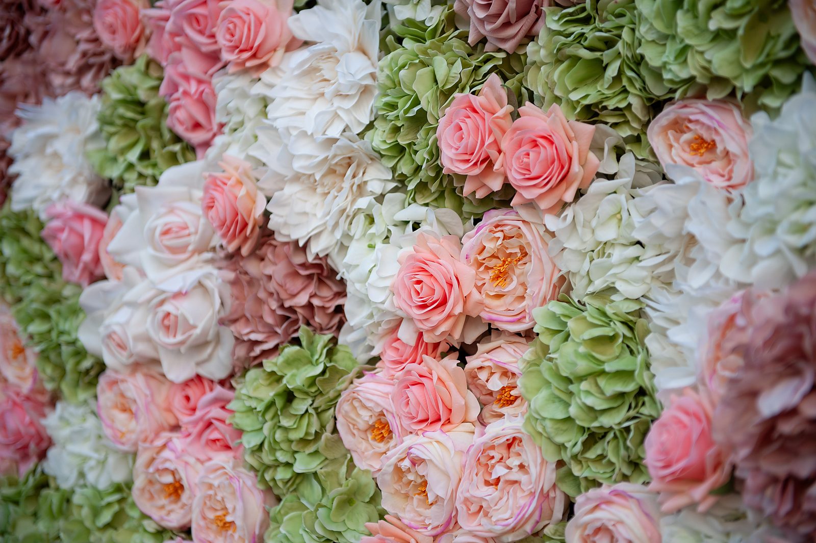 Detail view of sage green and dusty pink Real Touch flowers
