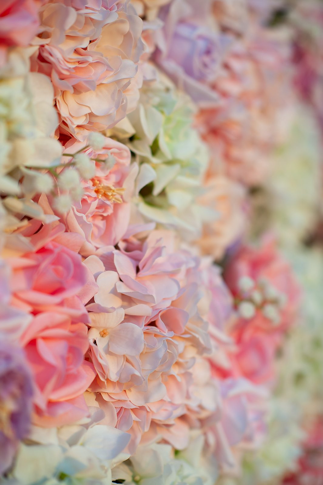 Close-up of blush, mauve and ivory Real Touch roses in the Blush Cascade wall