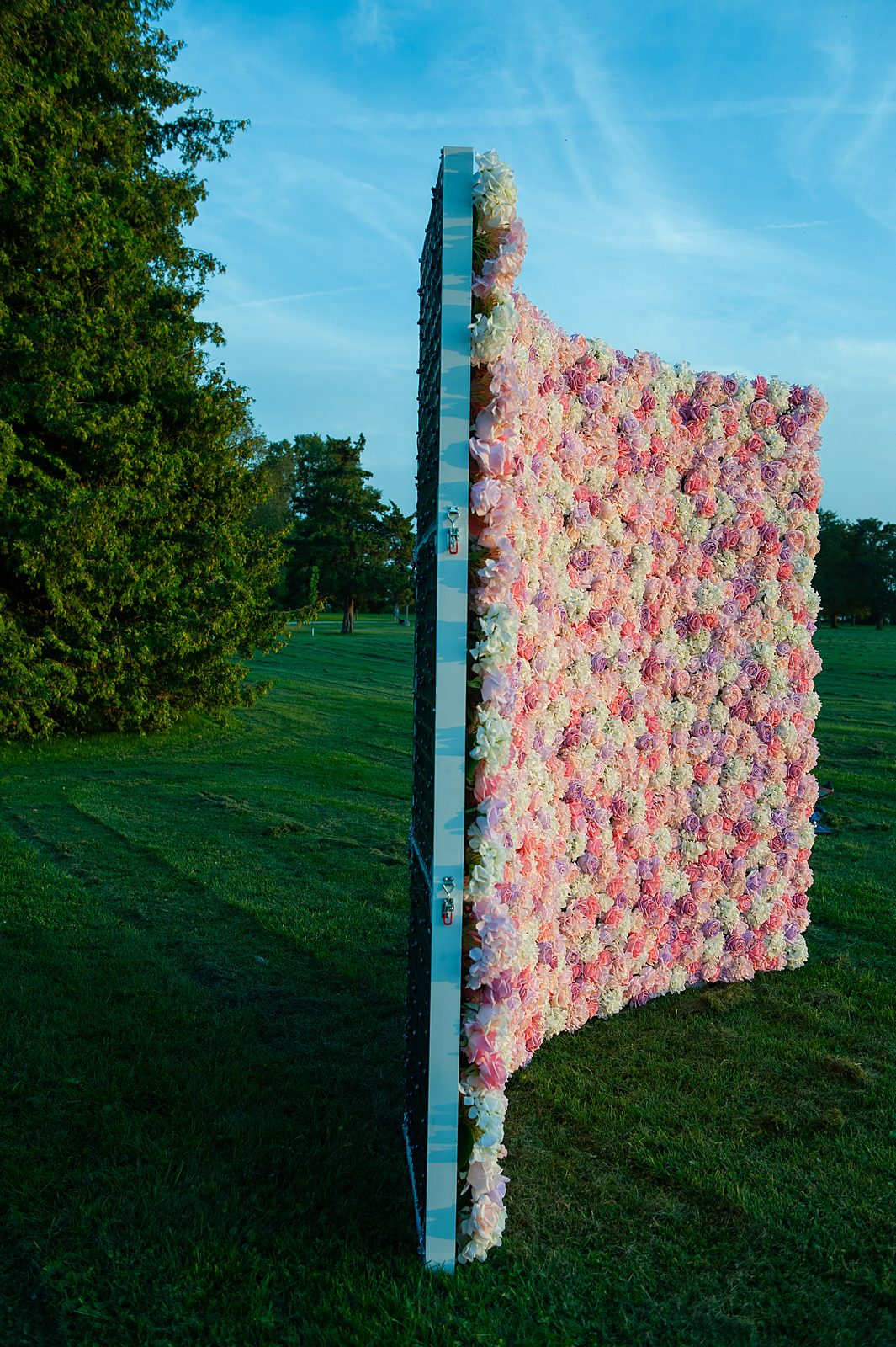 Blush Cascade flower wall standing in a field at dusk — Real Touch backdrop for GTA events